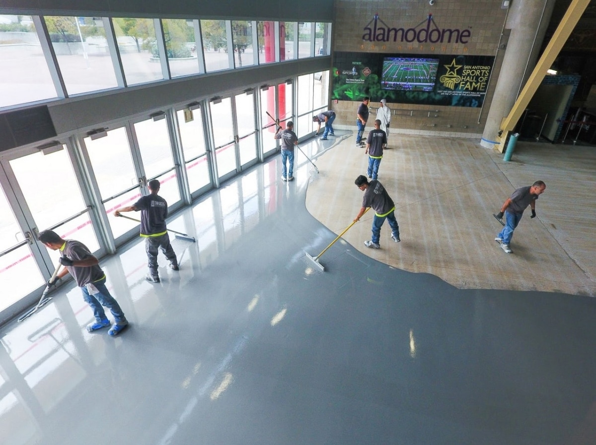 Manchester Group employees working on floor coating for Alamodome